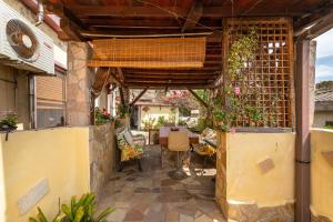 an outdoor patio with a table and chairs at Monolocale Il Girasole in Villaputzu