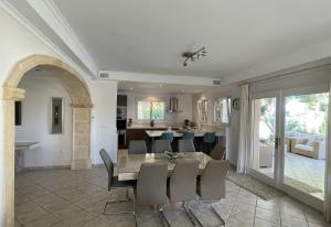 a dining room and living room with a table and chairs at Gloriann in Moraira