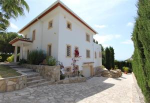 a large white house with a stone driveway at Gloriann in Moraira