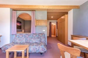 a living room with a couch and a table at Sabina Dolomites Euringer in Alpe di Siusi +11 photos