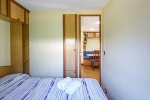 a bedroom with a bed with two towels on it at Bungalow B1 in Pontevedra +19 photos