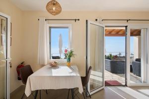 a dining room with a table and a balcony at Casa Inti in Tijarafe