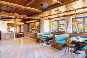 a living room with a blue couch and tables at Pension Heidelberg in Hopfgarten im Brixental
