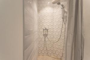 a shower with a shower head in a bathroom at Peaceful Countryside Getaway in Parbayse