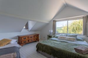 a bedroom with two beds and a window at Peaceful Countryside Getaway in Parbayse