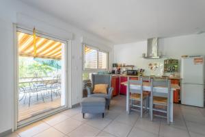 a kitchen with a refrigerator and a table and chairs at Peaceful Countryside Getaway in Parbayse