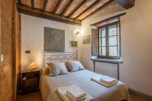 a bedroom with a bed with towels on it at Casale Rosennano - Loggia in Rosennano +23 photos