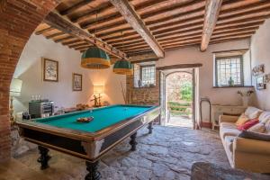 a pool table in a living room with a ceiling at Casale Rosennano - Loggia in Rosennano