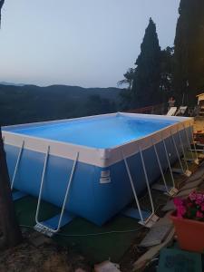a large blue swimming pool with a cover around it at Casale Rosennano - Loggia in Rosennano