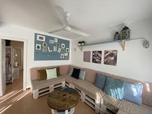 a living room with a couch and a table at Lola's Beach House in Calafell