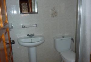 a bathroom with a toilet and a sink at El Castillito in Begur +10 photos