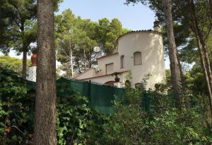 a house with a fence in front of it at El Castillito in Begur