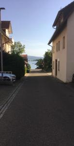 an empty street next to a building and a body of water at Fewo im schönen Allensbach in Allensbach
