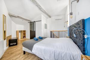 a bedroom with a large bed with blue pillows at Les gîtes de virginie in Bourg-sur-Gironde