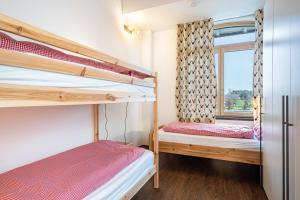 two bunk beds in a room with a window at Käserei in Argenbühl