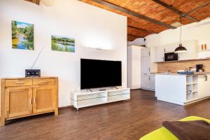 a living room with a large flat screen tv at Käserei in Argenbühl