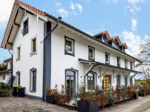 a white house with black windows at Käserei in Argenbühl