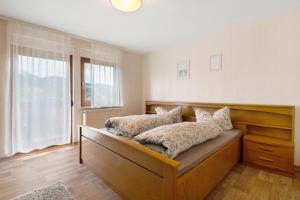 a bedroom with a bed with pillows on it at Ferienhof Brutoni in Bad Peterstal-Griesbach