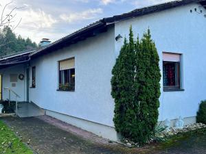 a blue house with a tree in front of it at Lerchenglück in Lottstetten +2 photos