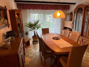 a dining room with a wooden table and chairs at Lerchenglück in Lottstetten