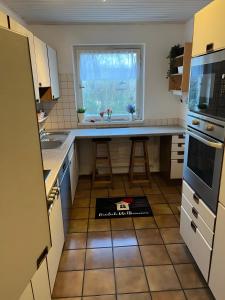 a kitchen with a counter and a sink and a window at Lerchenglück in Lottstetten