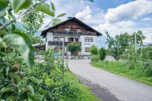 a house on the side of a road at Apartment Tschigat Leilichhof in Lana +4 photos