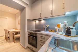 a kitchen with a sink and a stove top oven at Seawind Gouvia in Corfu