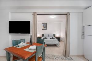 a living room with a dining table and a bed at Las Flores 1D in Costa de Adeje