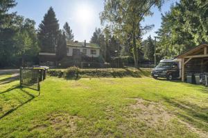 a van parked in a yard next to a house at Haus Wildgans in Lychen