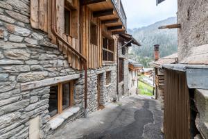 an alley in a mountain village with stone buildings at Lodge Alouette in Champagny-en-Vanoise
