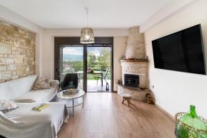 a living room with a couch and a fireplace at Lefkada view villa Vasiliki 1 in Peratiá