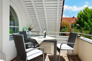 a patio with a table and chairs on a balcony at Wohlfühlplatz in Ostrach