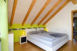 a bedroom with a bed and a wooden ceiling at Wohlfühlplatz in Ostrach