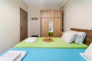 a bedroom with a bed with a hat on it at Lefkada view villa Vasiliki 1 in Peratiá