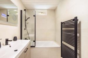a bathroom with a shower and a white sink at Haus am See in Quickborn +22 photos