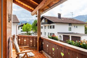 a balcony with a view of a house at Alpblick Apartment Alpspitze in Garmisch-Partenkirchen