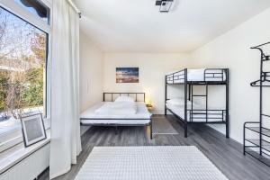a bedroom with two bunk beds and a window at Haus am See in Quickborn