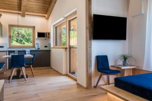 a living room with a kitchen and a dining room at Chalet Kasch Apartment Berg in Völs am Schlern