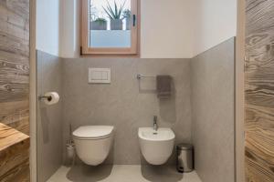 a small bathroom with a toilet and a sink at Chalet Kasch Apartment Berg in Völs am Schlern +23 photos