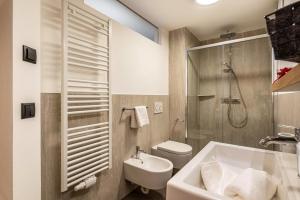 a bathroom with a sink and a toilet and a shower at Planerhof Apartment Alpenrose in Funes +26 photos