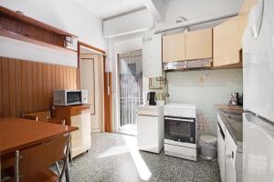 a kitchen with white appliances and a table at Condominio Sereno in Rapallo