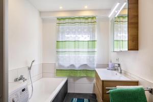 a bathroom with a tub and a sink at Ameisberger - Landhaus in Mollmannsreith +22 photos