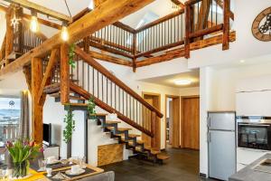 a staircase in a kitchen with wooden beams at Ameisberger - Landhaus in Mollmannsreith