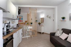 a kitchen and a living room with a couch and a table at Vista Al Paraíso in El Pris