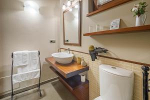 a bathroom with a sink and a toilet and a mirror at O Pozo in Ordes +19 photos
