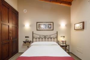 a bedroom with a bed and a wooden door at O Pozo in Ordes
