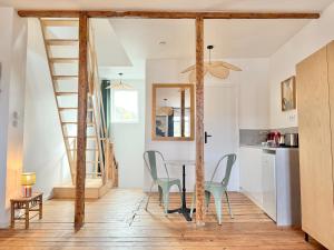 a kitchen and dining room with a staircase in a house at Résidence Gaïa - Etretat in Étretat