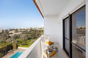 a balcony with a view of a swimming pool at Dreamalvor in Alvor