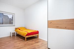 a small bedroom with a bed and a window at Cozy Ground Floor Apartment in Bremen