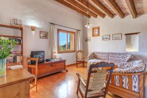 a living room with a couch and a tv at Can Vaja in Pollença